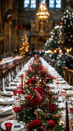 a long table is set with red roses and greenery for an elegant christmas dinner