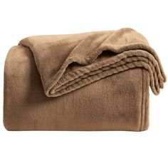 three blankets folded on top of each other in brown color, with one blanket folded over it