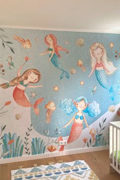 a child's room with mermaid themed wallpaper