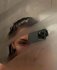 a woman taking a selfie in the mirror