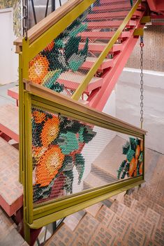 a staircase made out of legos with oranges on the bottom and green railing