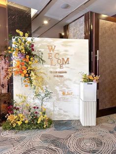 a floral display in front of a welcome sign