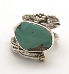 Sterling silver twig style ring with bronze accent and bezel set turquoise approximate width 3/4 of an inch.Note: turquoise may vary slightly Turquoise Bohemian Rings With Gemstone Accents, Bohemian Turquoise Rings With Gemstone Accents, Artisan Turquoise Ring Jewelry, Turquoise Jewelry With Bezel Setting For Anniversary, One Of A Kind Turquoise Jewelry For Anniversary, Fine Jewelry Turquoise Bezel Setting, Unique Turquoise Ring Jewelry, Heirloom Turquoise Jewelry Gift, Heirloom Turquoise Jewelry For Gift