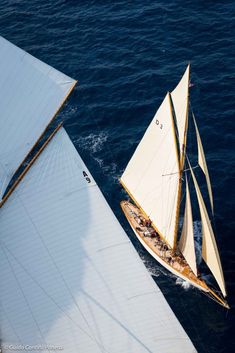 two sailboats in the water near each other