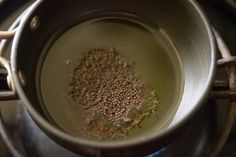 a pot filled with lots of spices on top of a stove