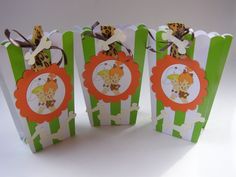 three green and white striped paper bags with animals on them, one has an orange bow