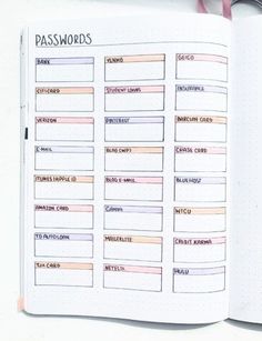 an open planner with pink and blue lines on it, next to a pen and scissors