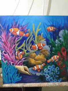 a painting of clown fish in an aquarium