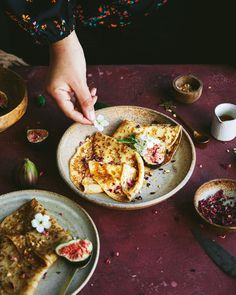 a person reaching for food on a plate