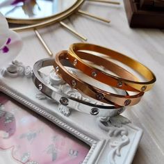 Discover the classic charm and contemporary appeal of Marrakech through these bangles. Featuring embedded crystals of varying widths (3mm, 6mm, and 9mm), these bangles shimmer like the golden sands of Morocco. Wear them solo for a touch of exotic allure or stack them for a daring fashion statement. Each set includes 3 bangles in silver, gold, and rose gold, allowing you to carry the enchantment of Marrakesh with you wherever you go. Bangles Set, Bangle Set, Marrakech, The Golden, Jewelry Care, Fashion Statement, Morocco, Timeless Elegance, Silver Gold