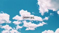 the words dream big are written in the clouds