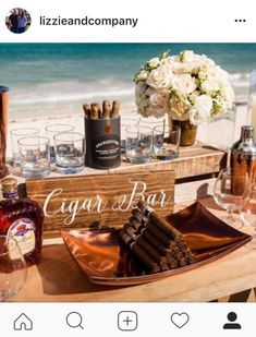 a wooden table topped with lots of bottles and glasses