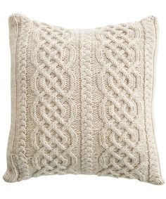 a white knitted pillow on a white background