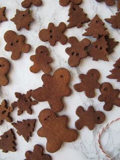 gingerbread cutouts are arranged on a marble surface