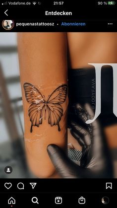 a woman's arm with a butterfly tattoo on it