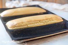 two long loafs of bread sitting on top of a pan