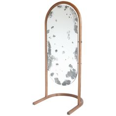 a wooden stand with a large mirror on it's top and one leg in the middle