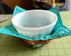 a bowl sitting on top of a cutting board