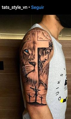 a man with a lion and cross tattoo on his arm