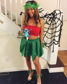 a woman in a costume standing next to a stair case