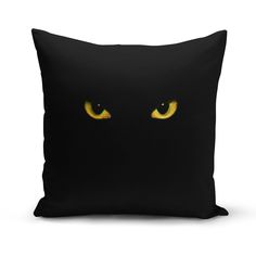 a black pillow with yellow eyes on it