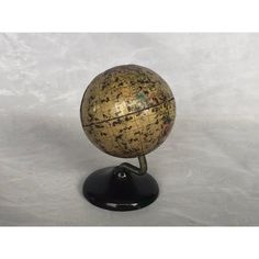 a small globe sitting on top of a black stand