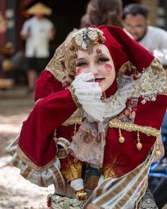 a woman dressed in costume is talking on her cell phone