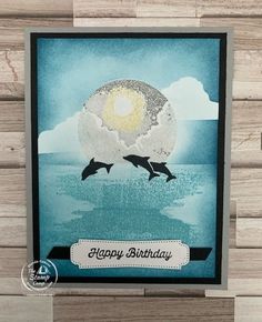 a card with two dolphins jumping out of the water