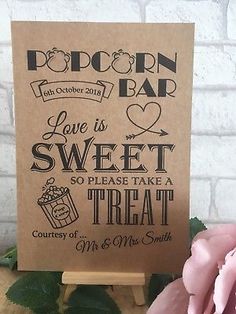 a sign that says popcorn bar love is sweet so please take a treat