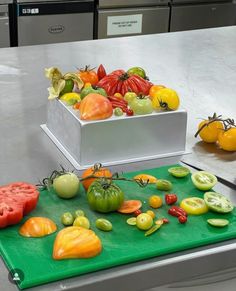 there are many different types of tomatoes on the counter top, including one red and one green