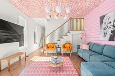 a living room filled with furniture and pink walls