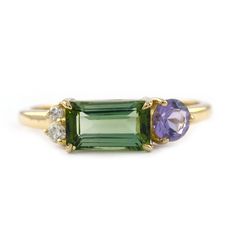 three stone ring in yellow gold with green and purple stones