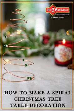 a christmas tree sitting on top of a table next to a jar with candles in it