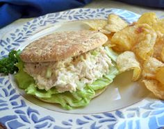 a sandwich and potato chips on a blue and white plate with a blue floral design