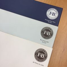 three different colored envelopes sitting next to each other