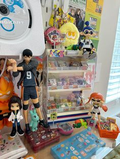 there are many toy figurines on display in this room, including one boy and two girls