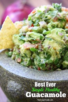 a bowl filled with guacamole and tortilla chips