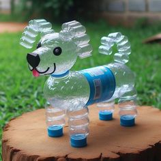 a dog made out of plastic bottles sitting on top of a tree stump