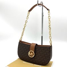 Brand New With Tag Michael Kors Carmen Small Pouchette Crossbody Bag Color: Brown Material: Saffiano Gold-Tone Hardware Chain Handle Flap With Magnetic Snap Button Closure Interior Features: 1 Wall Pocket 9.25”W X 4.5”H X 2.75”D Formal Brown Baguette Bag With Branded Hardware, Brown Baguette Shoulder Bag With Branded Hardware, Brown Shoulder Baguette Bag With Branded Hardware, Elegant Brown Baguette Bag With Branded Hardware, Michael Kors Shoulder Bag With Gold-tone Hardware For Office, Wall Pockets, Small Crossbody Bag, Michael Kors Bag, Brown Gold