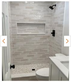 a bathroom with white tile and black hardware on the shower door, toilet and sink