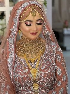 a woman wearing a bridal gown and jewelry