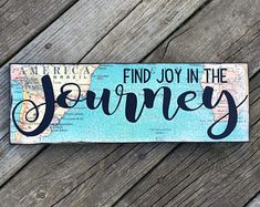 a wooden sign that says find joy in the journey