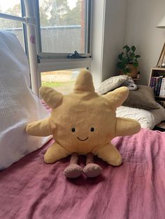 a stuffed animal sitting on top of a bed