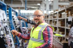 a man in safety vest working on electrical equipment