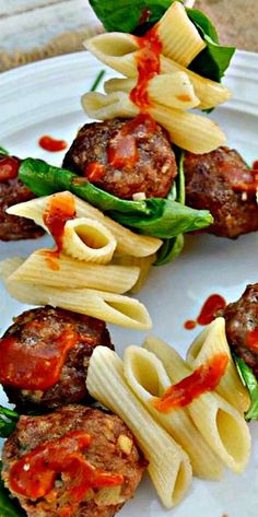 some meatballs and pasta on a white plate