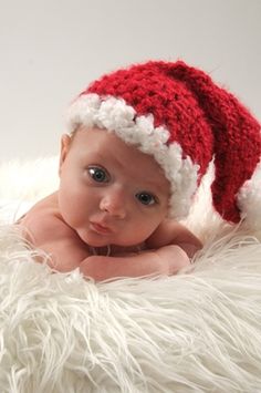 a baby wearing a red and white santa hat