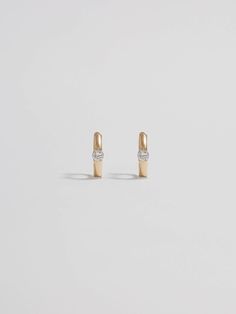 A hint of shine. Crafted from 14Kt gold, these huggie earrings are adorned with a single CZ stone that catches the light beautifully. Understated and unique, they can be worn alone or mixed with more maximalist styles. 14kt Yellow Gold 7.7mm Diameter 1.7mm Wide 1.11gr Made in Italy Materials Globally Sourced Fine Jewelry Gold Huggie Earrings With Single Diamond, Gold Huggie Earrings With Single Diamond, Formal White Gold Huggie Earrings With Single Diamond, Timeless Huggie Earrings With Single Diamond, Minimalist 14k Gold Huggie Earrings For Formal Occasions, Formal 14k Gold Huggie Earrings With Single Diamond, Modern Huggie Earrings With Diamond Accents, Formal Huggie Earrings With Single Diamond, Minimalist Single Diamond Hoop Earrings For Formal Events