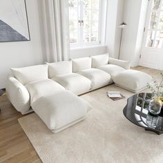 a living room with a large white sectional couch