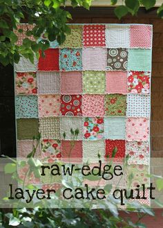 a large piece of cake sitting on top of a table next to a tree with the words raw edge layer cake quilt