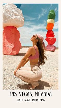 a woman sitting on the ground with her eyes closed in front of colorful rock formations